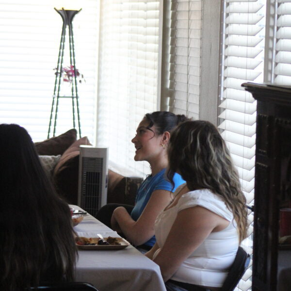 Young adults around a table for a small group Bible study.